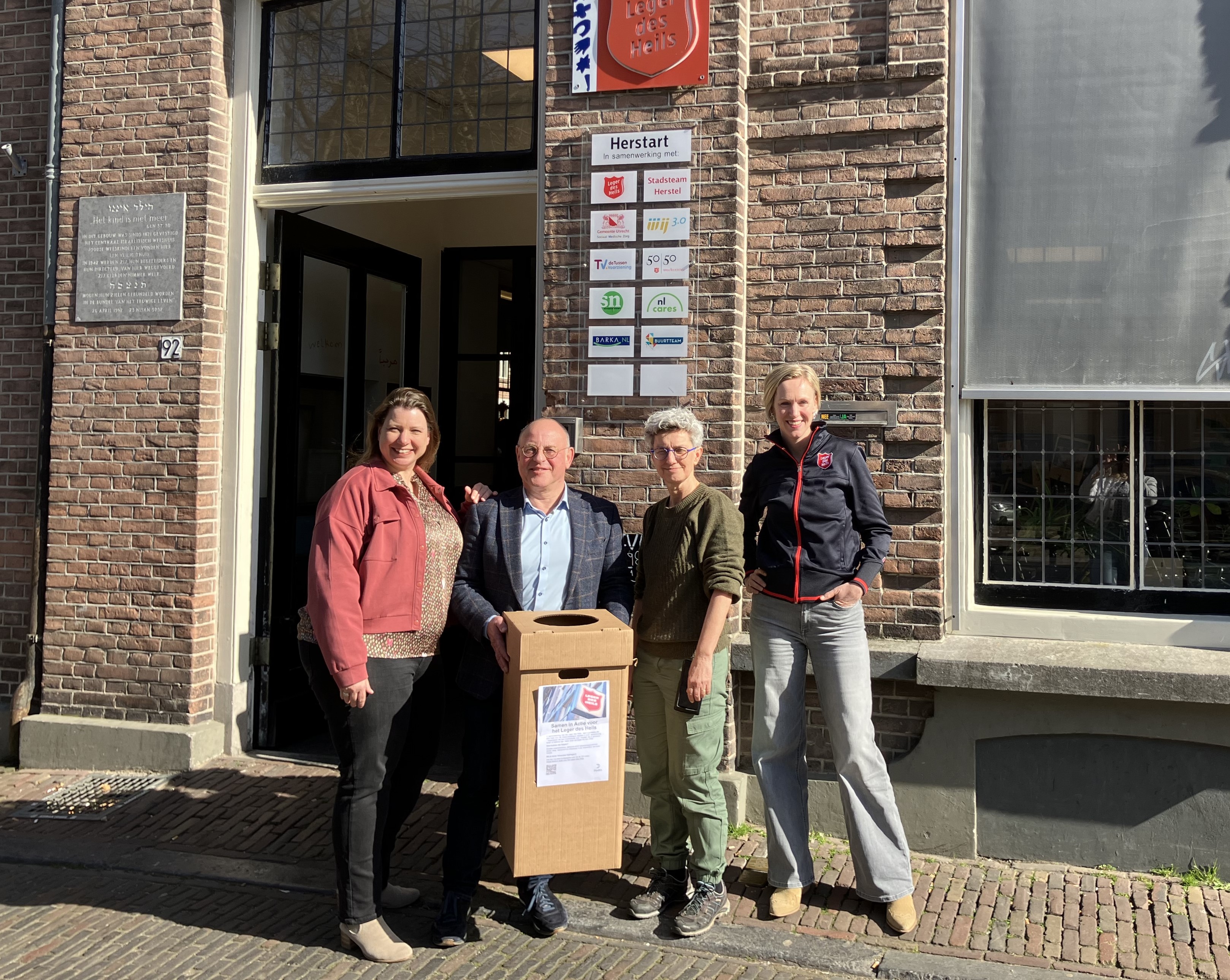 a group of people posing for a photo outside a building