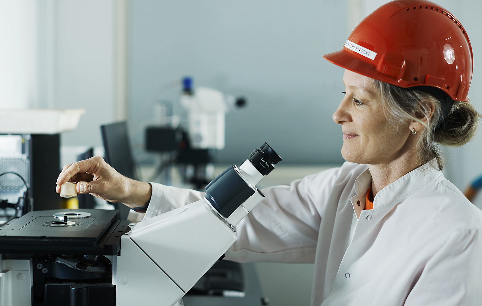 a person wearing a hard hat and holding a microphone