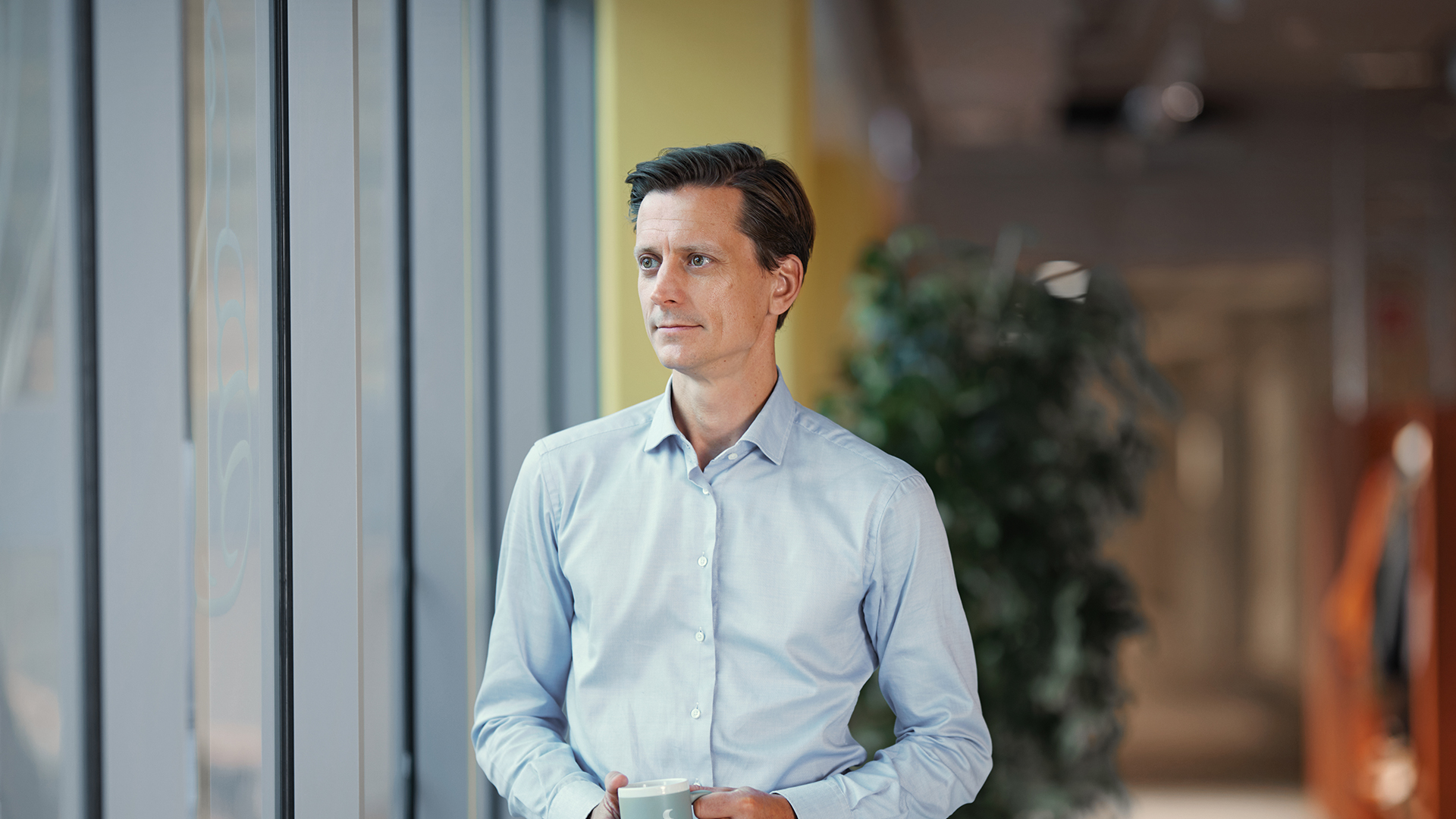 a man standing in front of a window