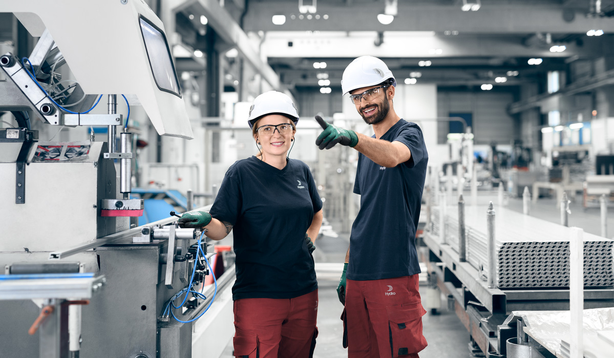 a man and woman wearing hard hats