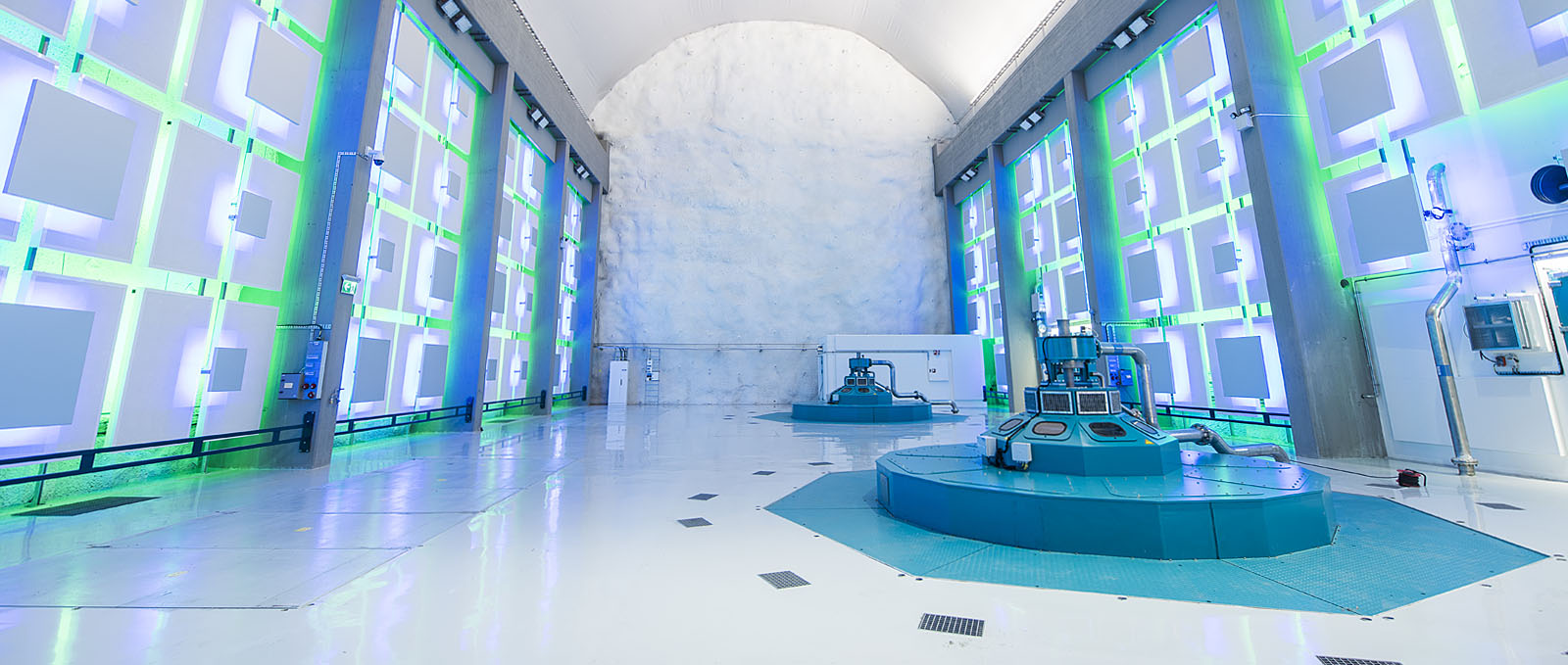 a room with a pool and a large white wall