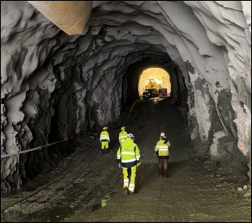 a group of men in yellow jackets in a cave
