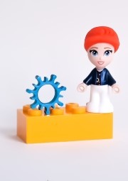a toy figurine of a boy with a blue hat and a red hat