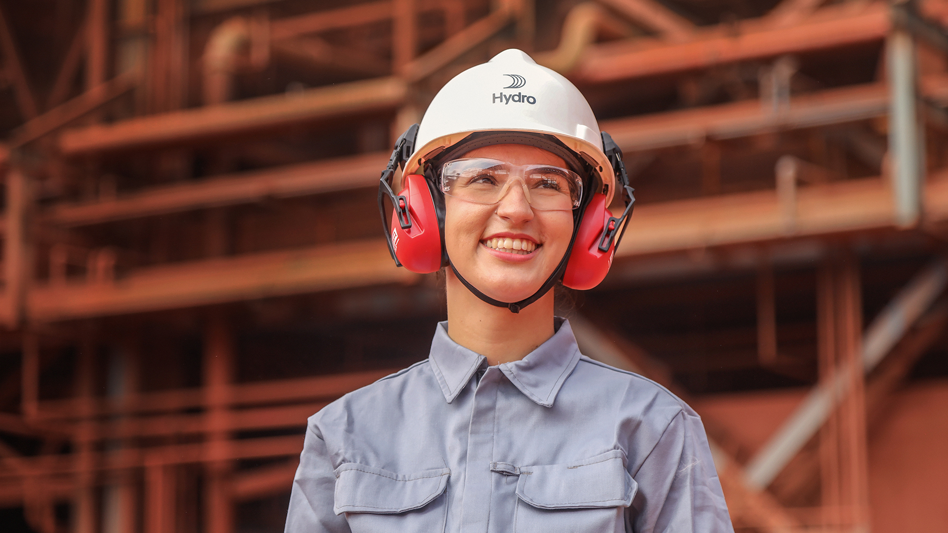 a woman wearing a hard hat and earmuffs