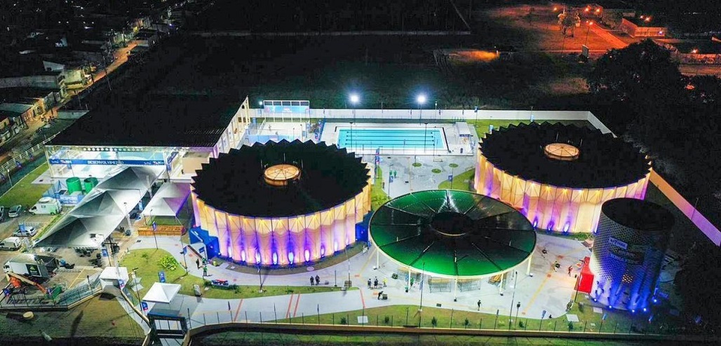 a large arena with a field and a large crowd of people