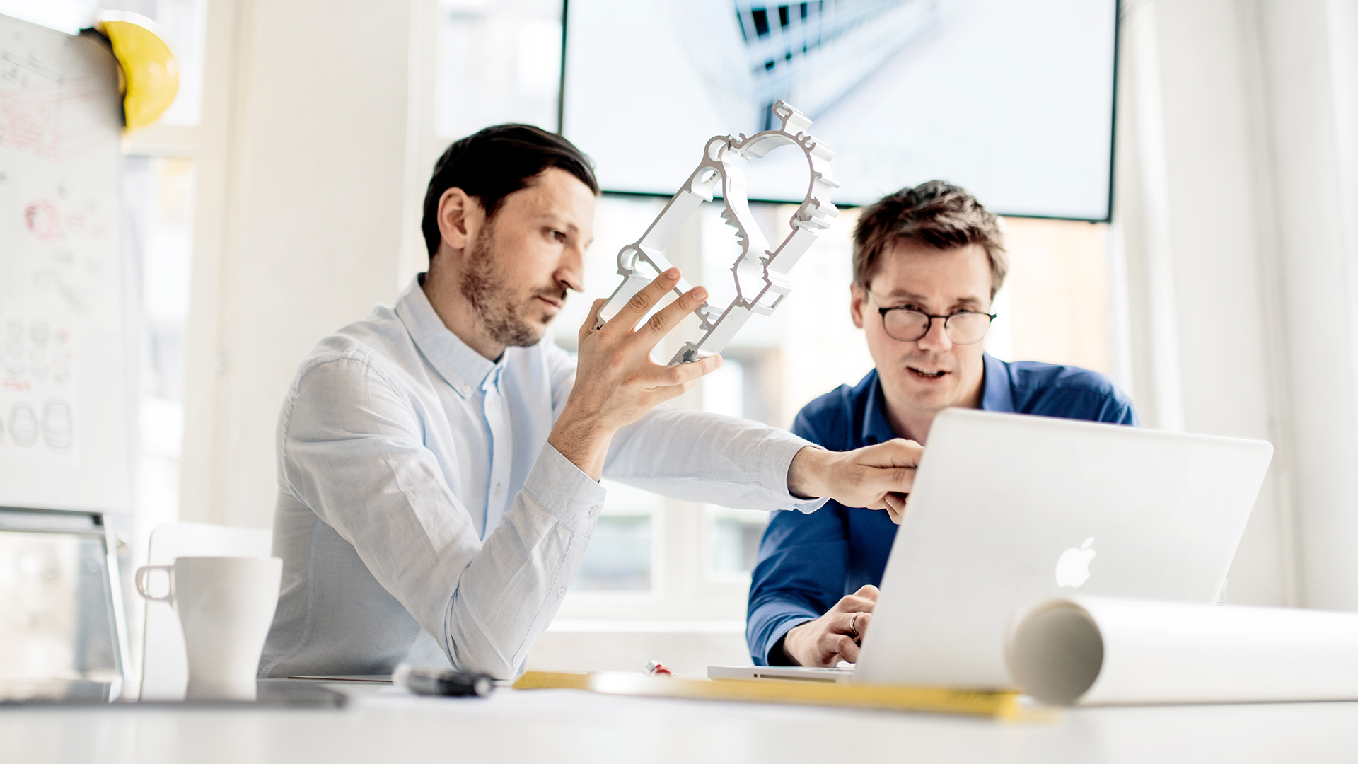 a person showing a person something on the computer